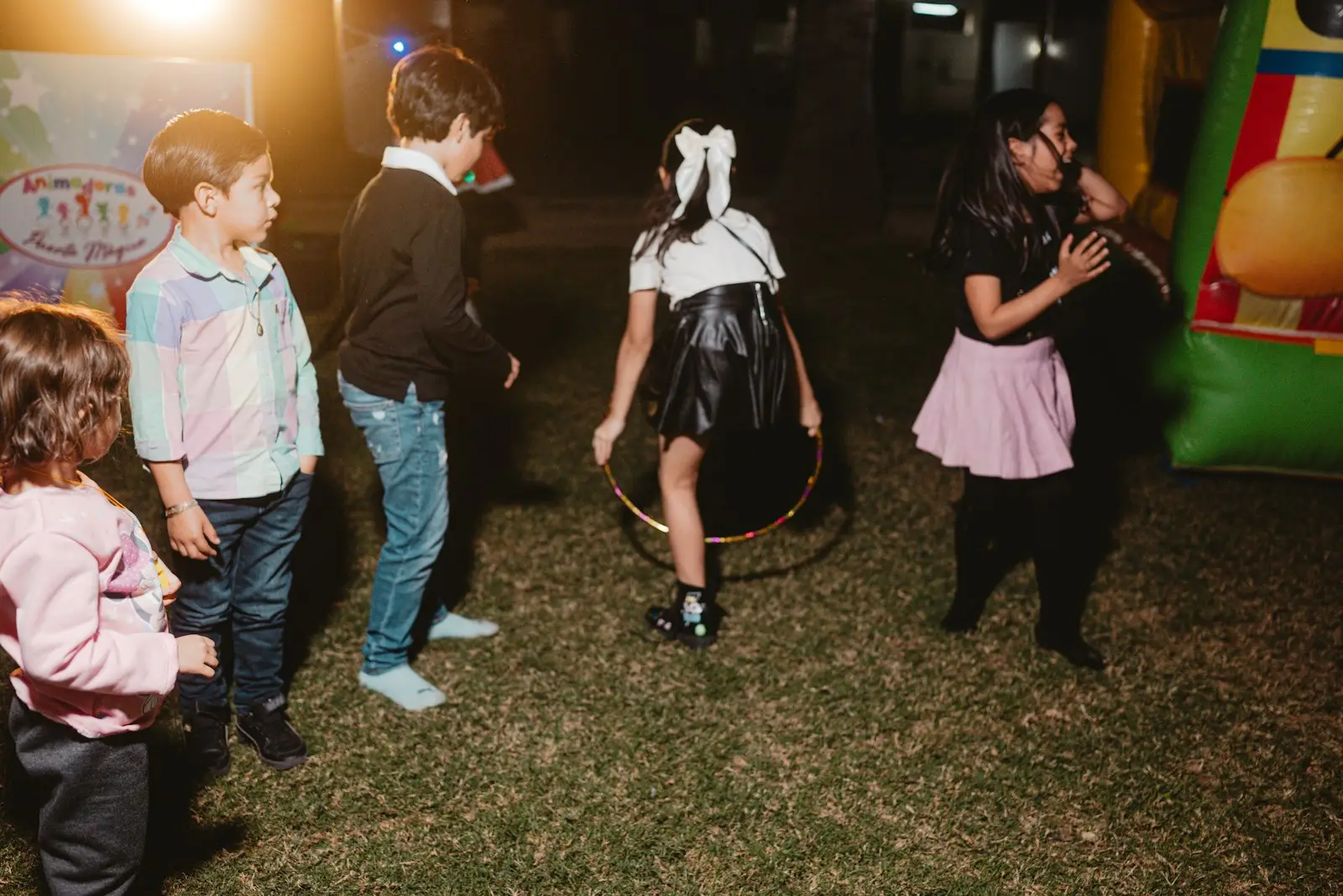 Children playing with a hula hoop at a party